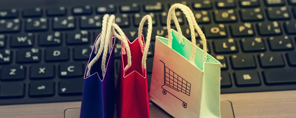 tiny shopping bags in front of a keyboard