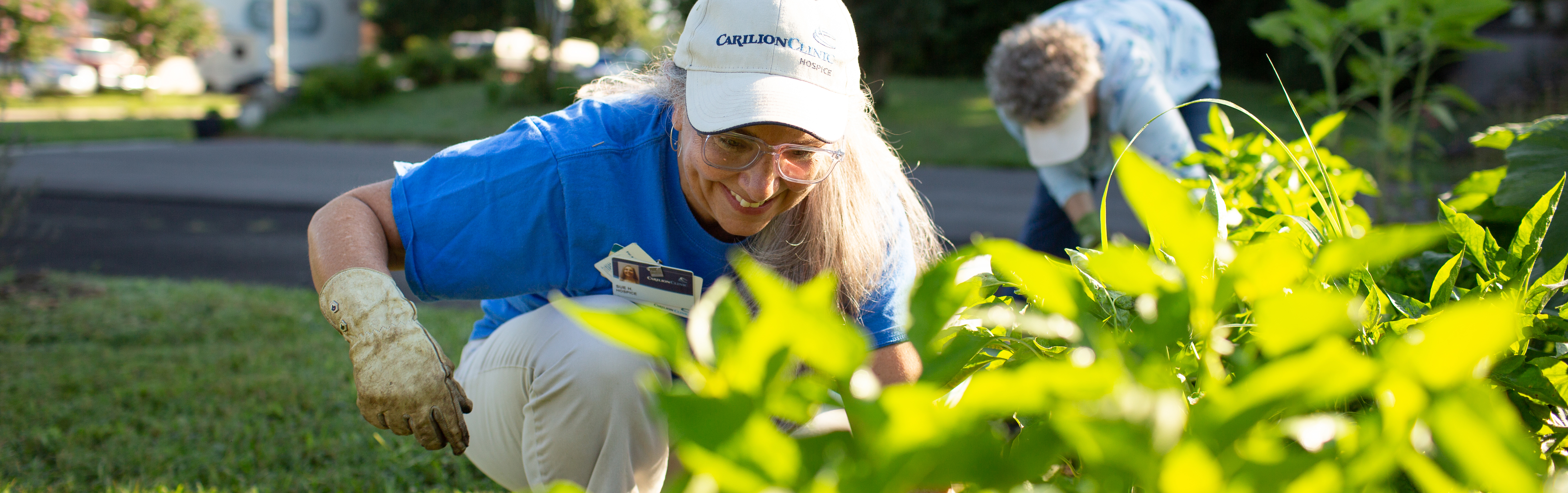 Sue Huntington pulling weeds in the community garden.