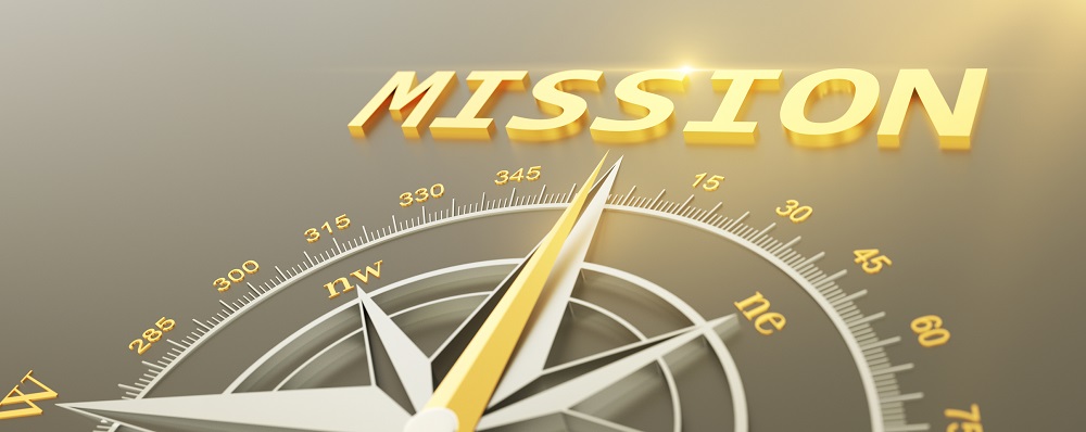 gold compass pointing to the word mission