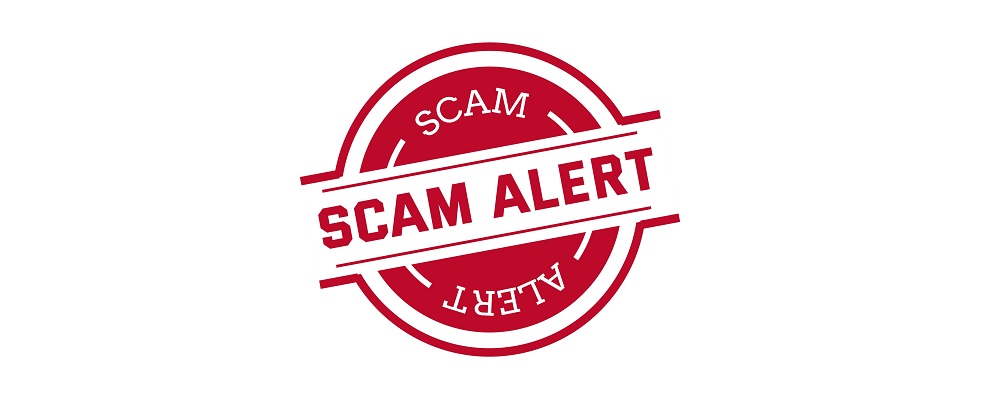 badge that says "scam alert"