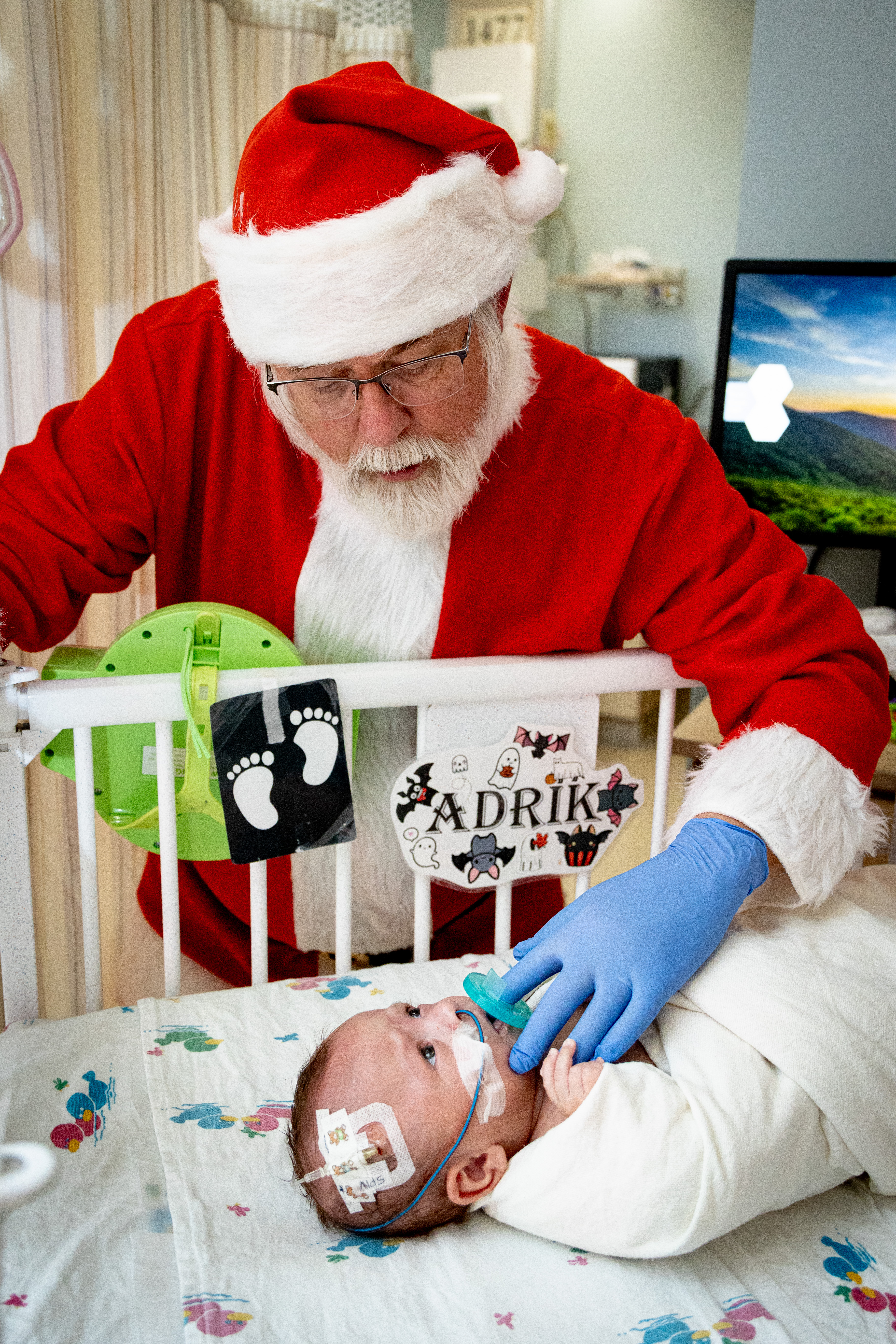 Santa visits with a NICU patient.
