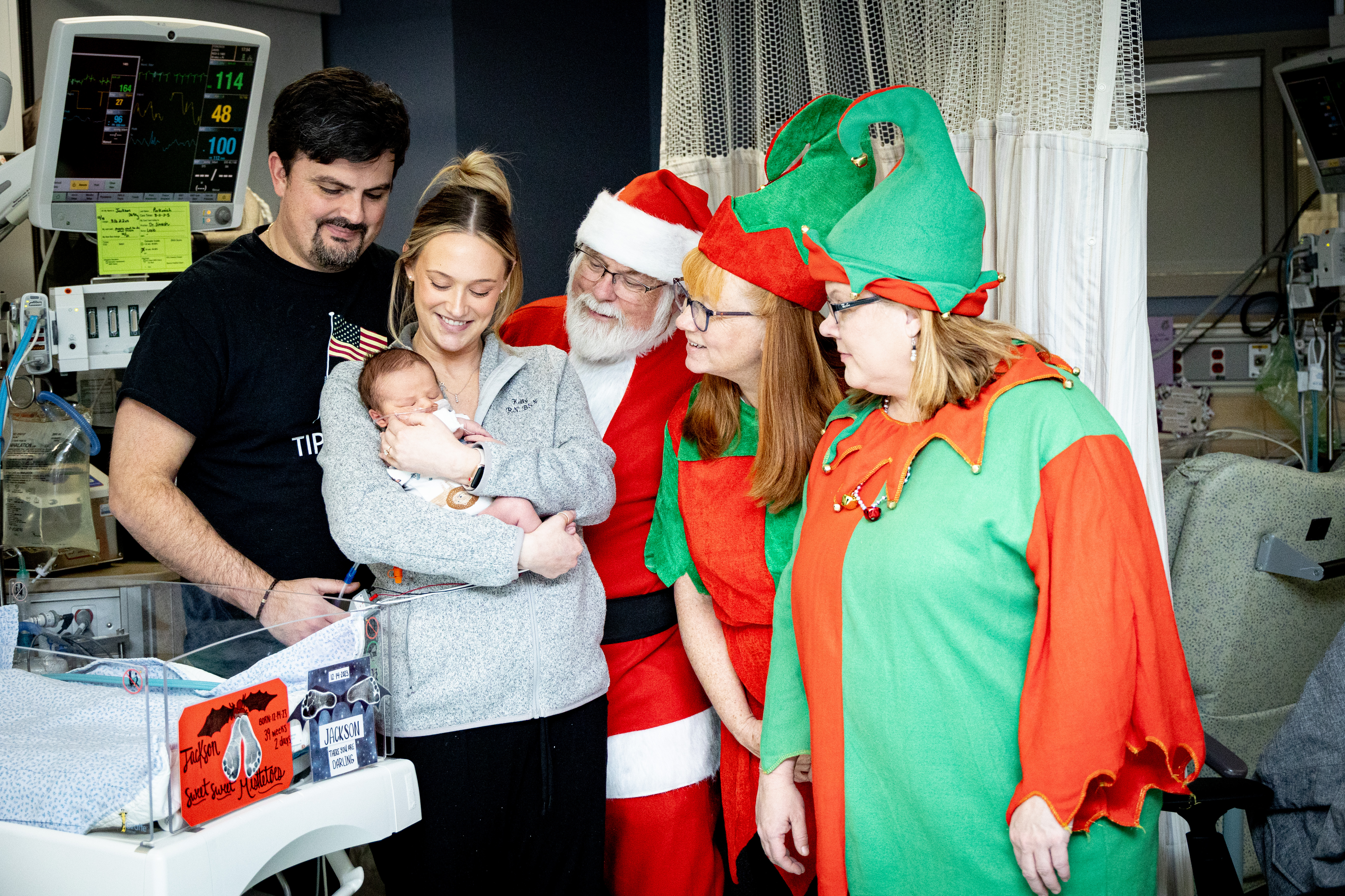Santa and his elves visit with a NICU patient and their family.