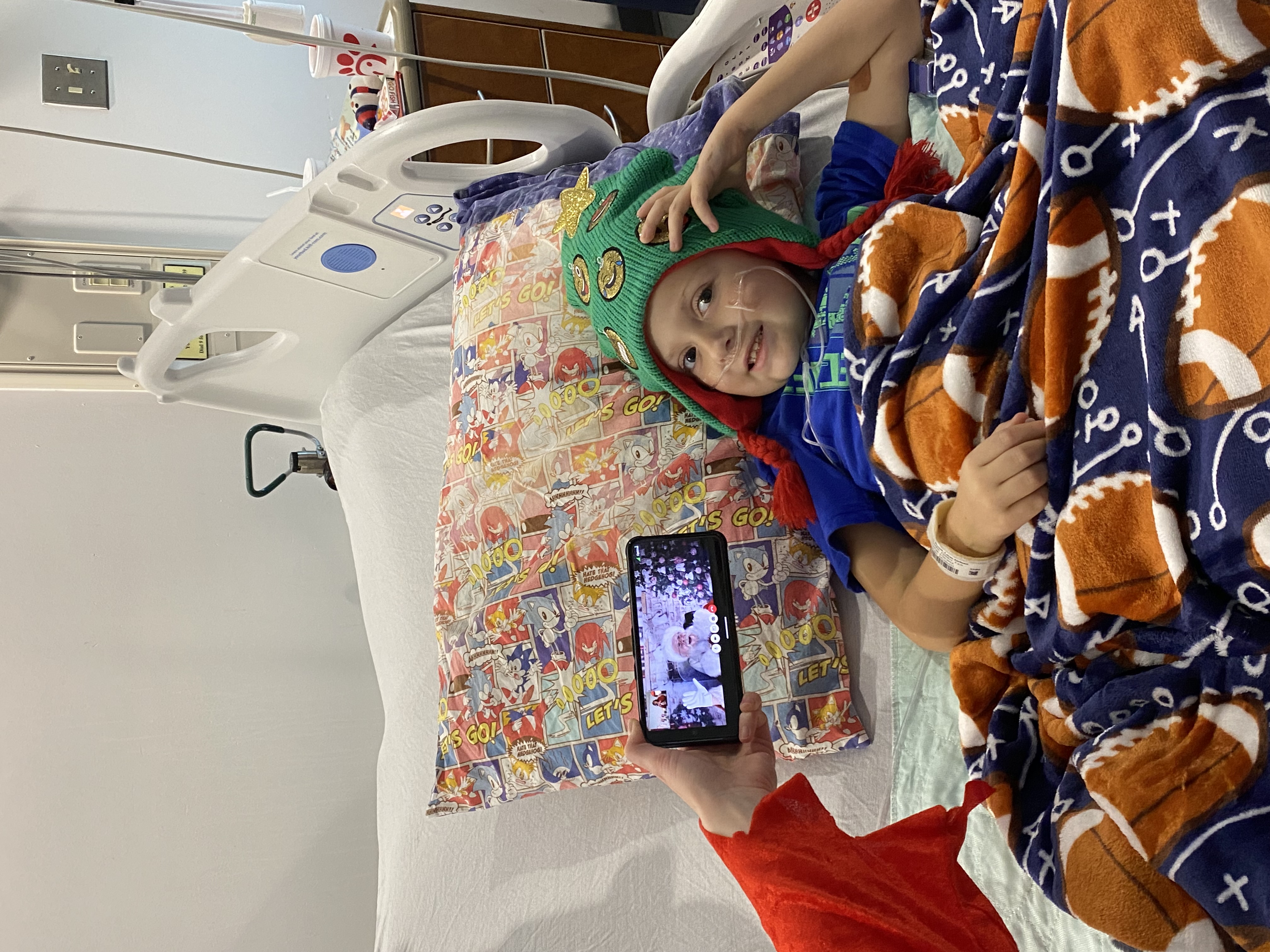 Santa visits with a pediatric patient virtually. 