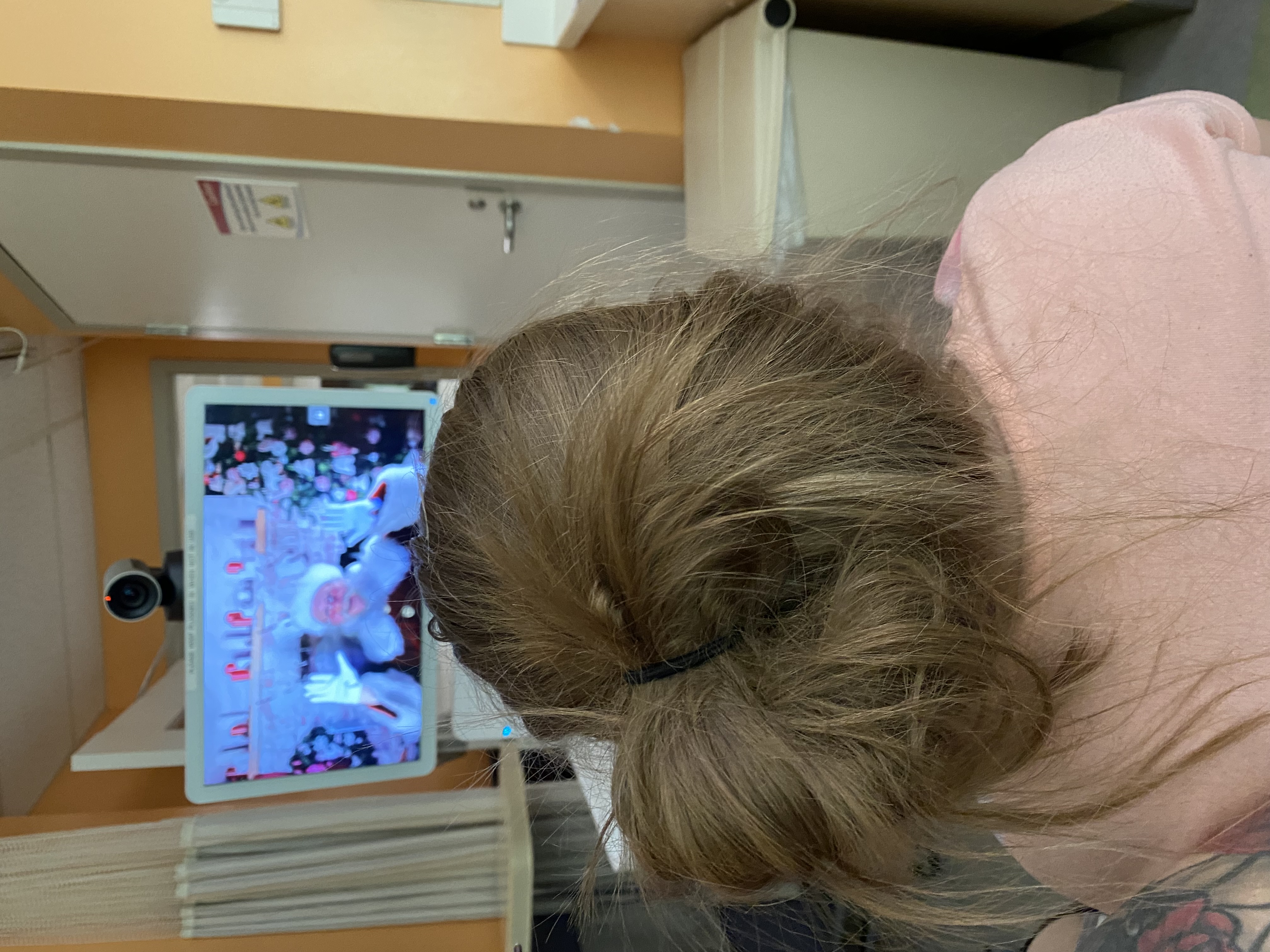 Santa visits with a pediatric patient virtually.