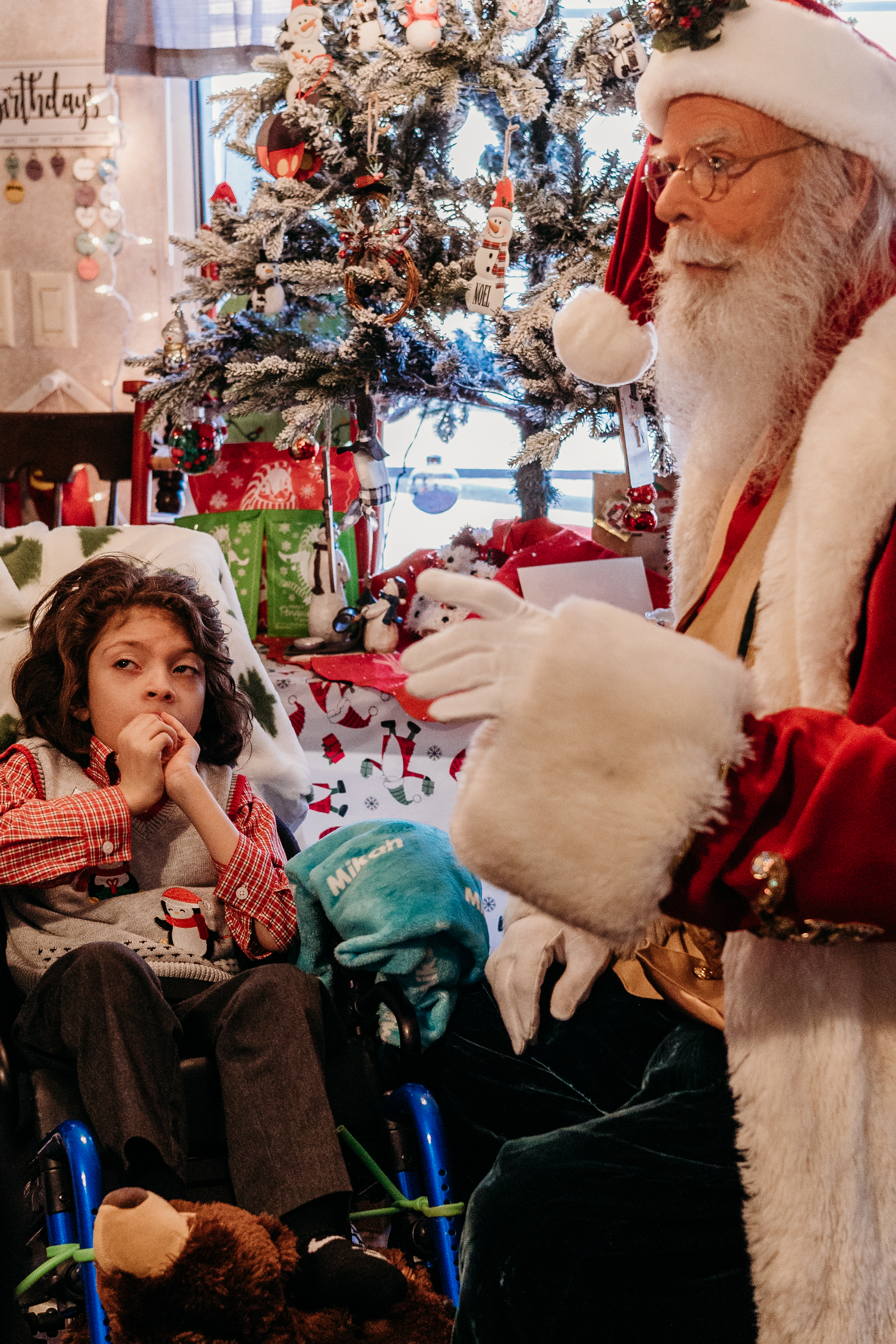 Santa visits with a pediatric hospice patient in their home.