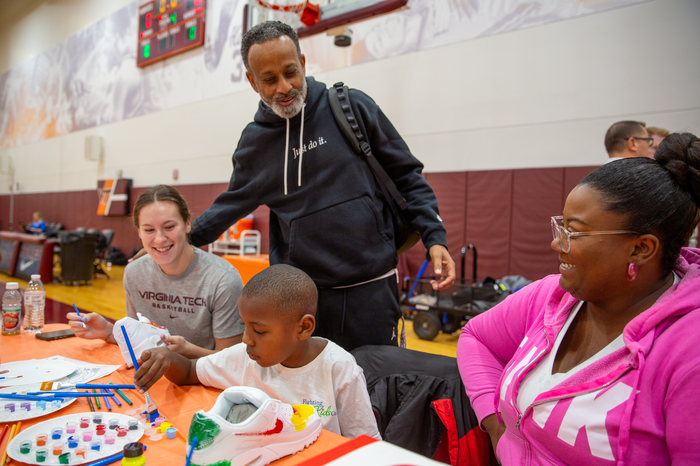 Virginia Tech Women's Basketball Coach Kenny Brooks and player Cayla King greet one of our young patients. 