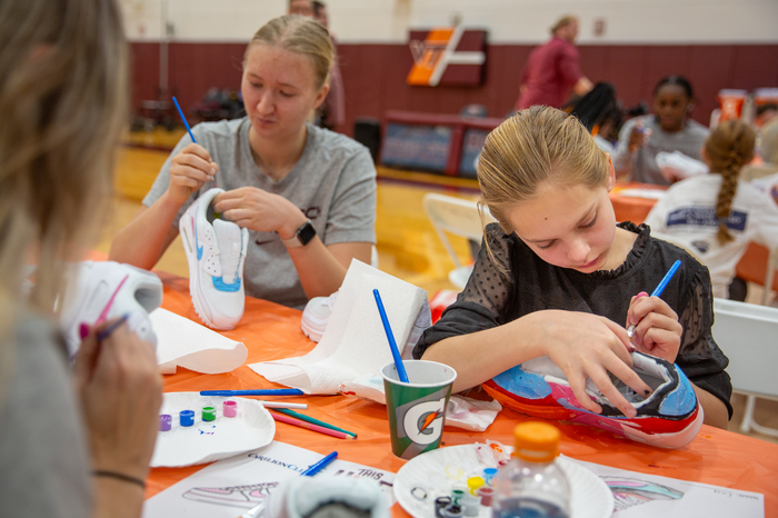 Virginia Tech Women's Basketball player Matilda Ekh painting with one of our young patients. 