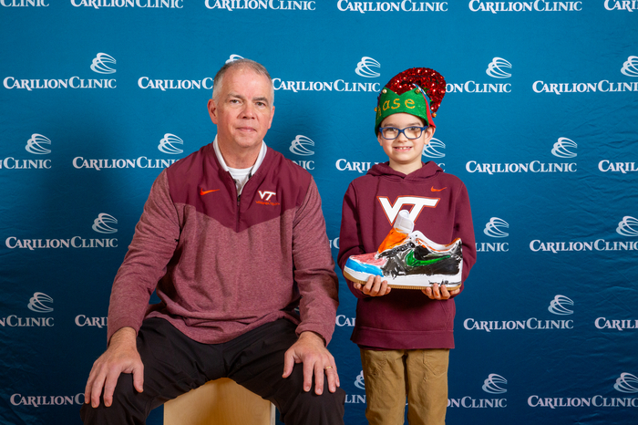 Virginia Tech Men's Basketball Coach Mike Young with his sneaker-painting partner and their sneaker.