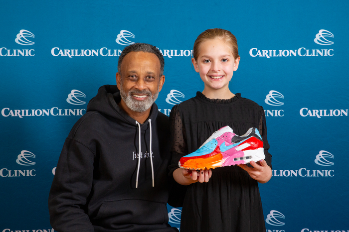 Virginia Tech Women's Basketball Coach Kenny Brooks with his sneaker-painting partner and their sneaker.