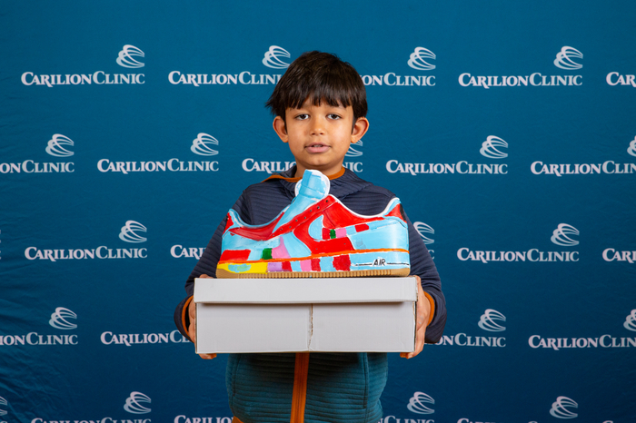 A pediatric patient shows off his wearable work of art. 