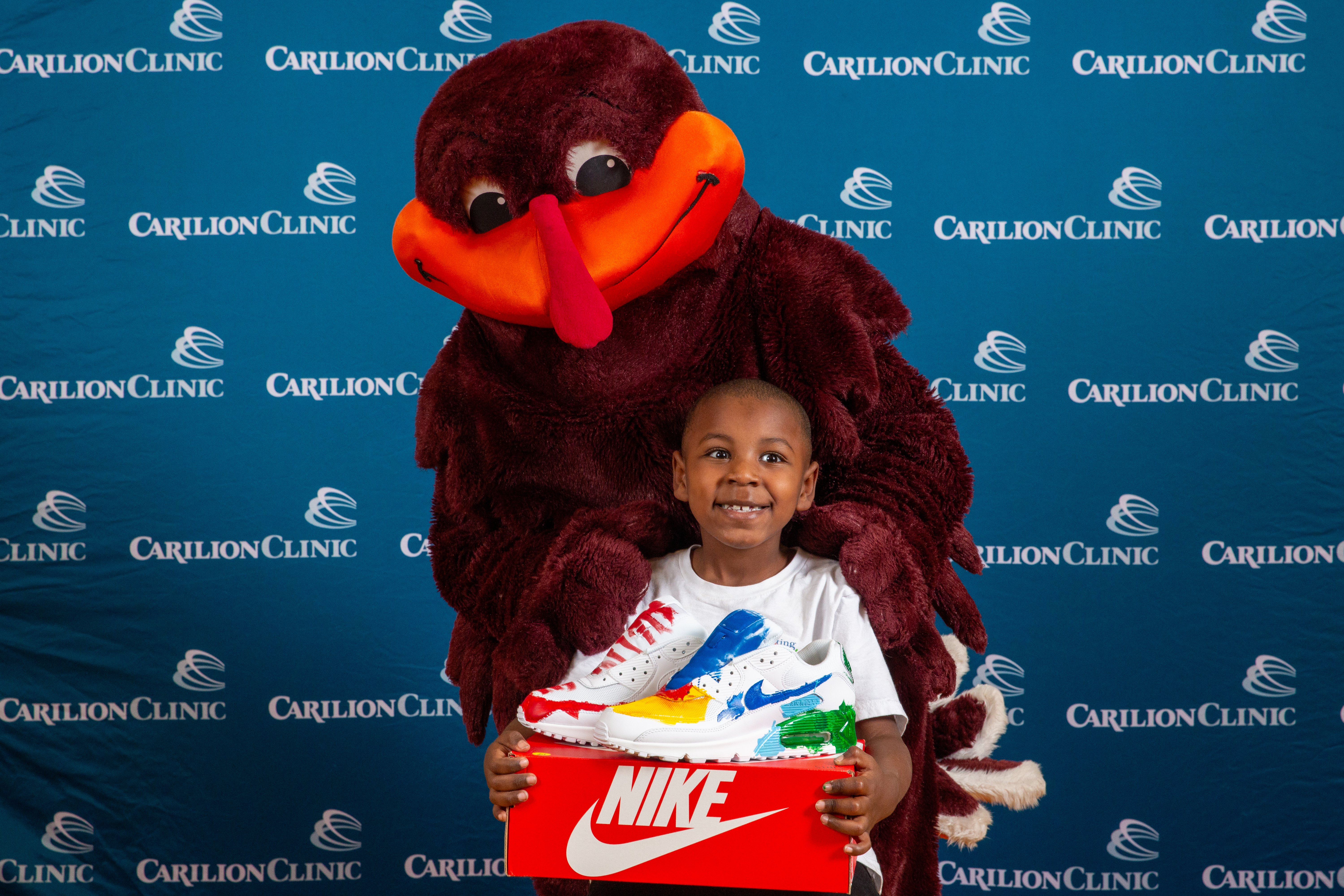 The HokieBird poses with a pediatric patient. 