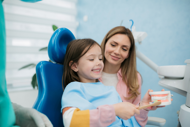 A young girl at the dentist.