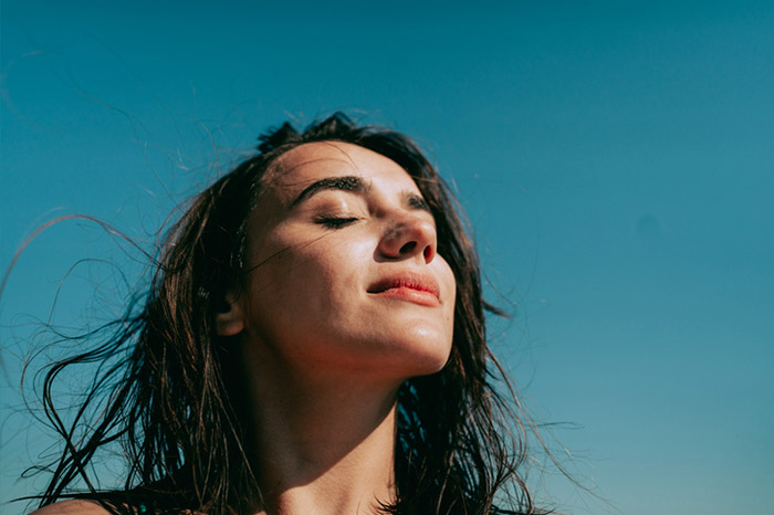 A lady meditating in the sunlight.