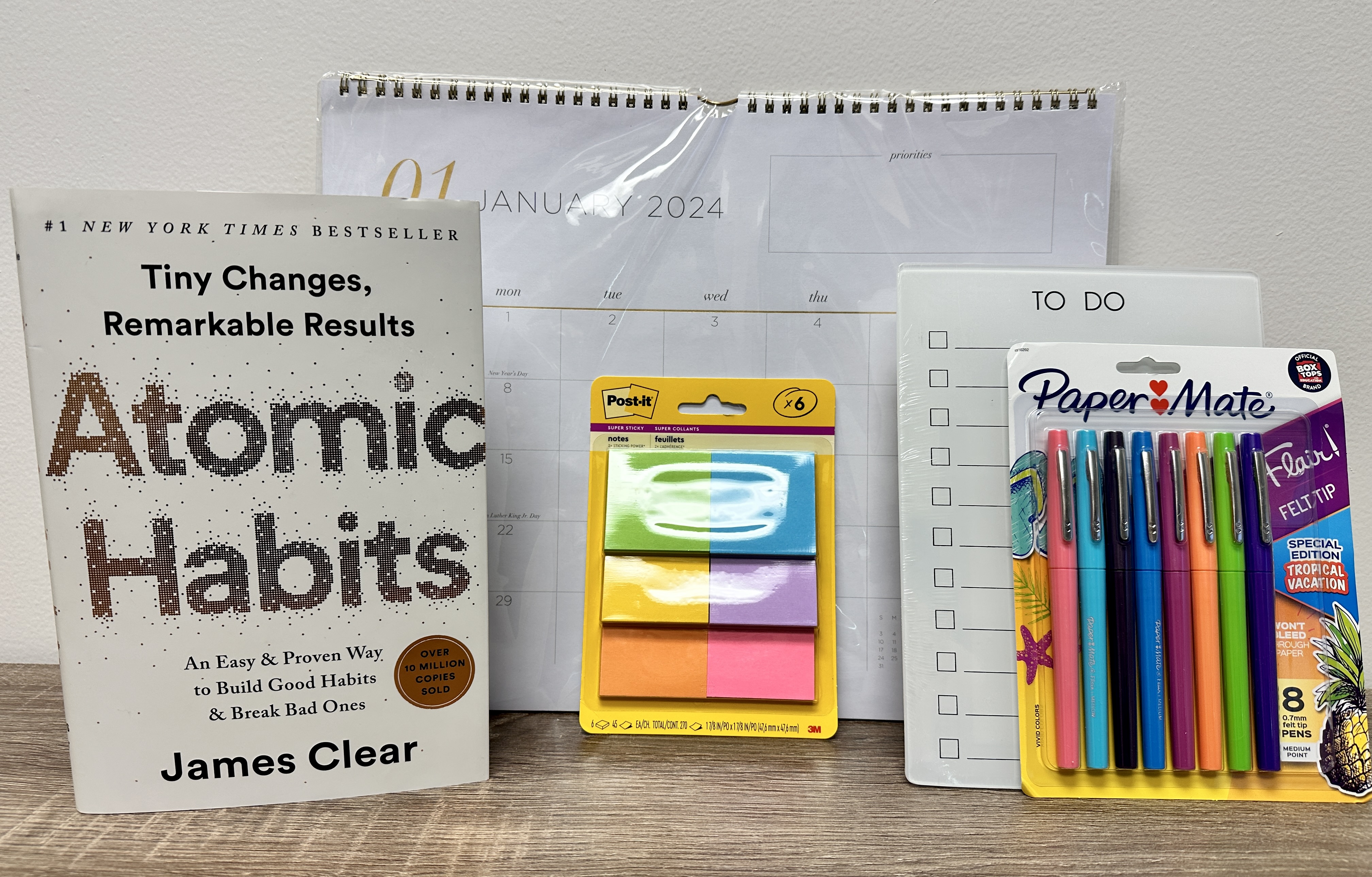 The Goal Getter Box: 2024 calendar, dry erase "to-do" board, felt tip pens, post it notes and "Atomic Habits"