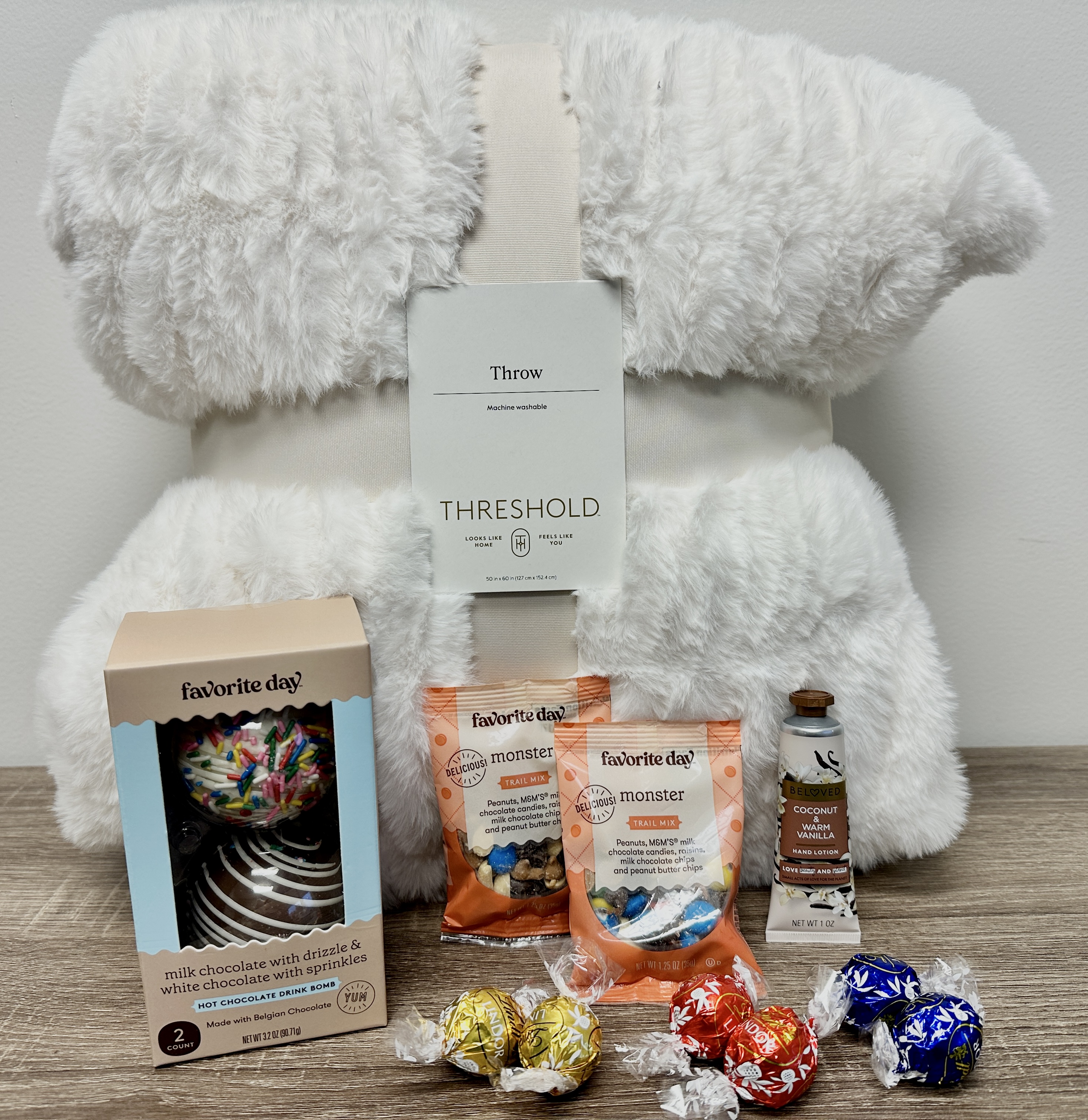 The Brrr Box: throw blanket, hot chocolate drink bombs, trail mix, chocolates and hand lotion