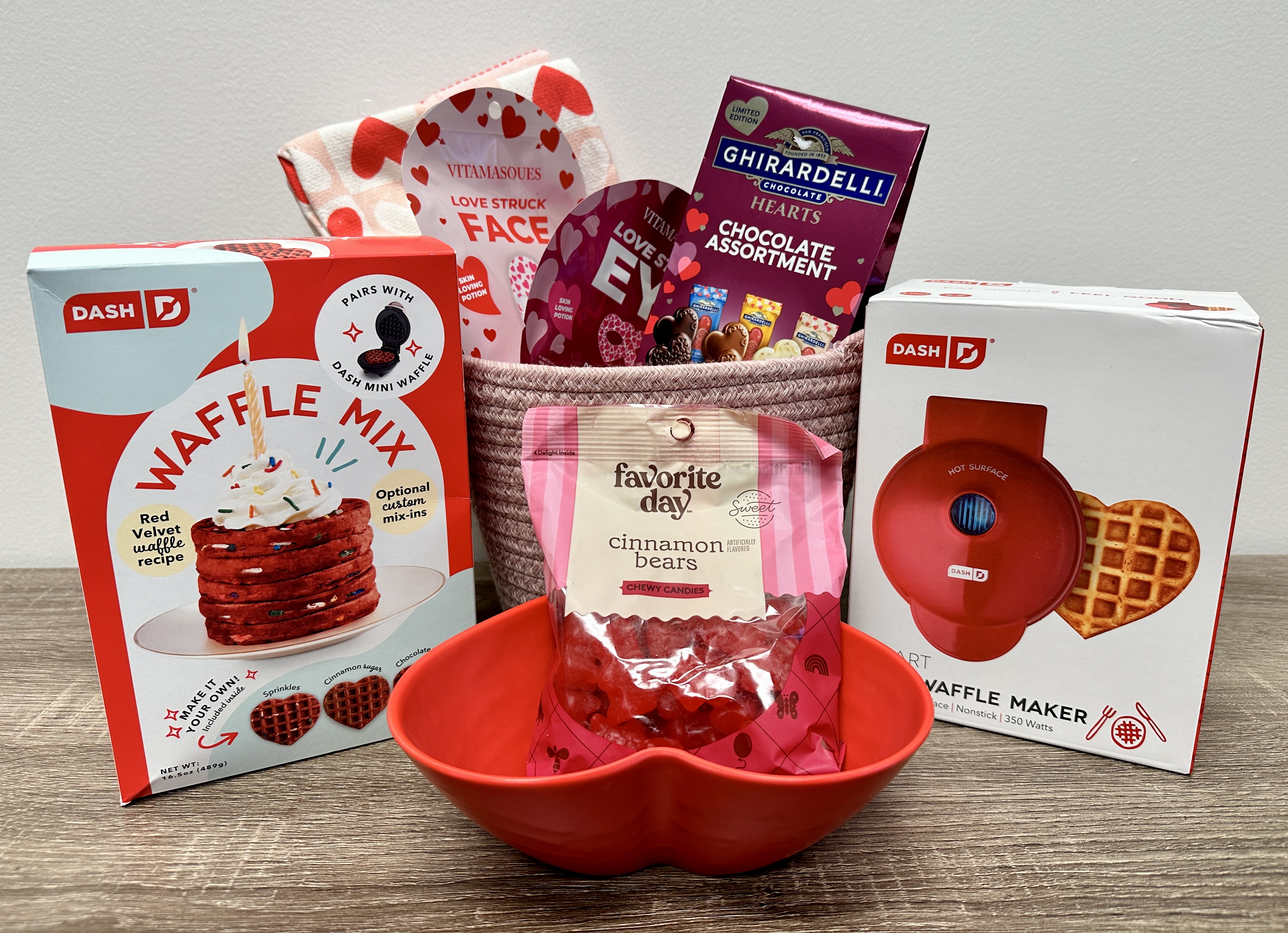 Share the Love Contest Grand Prize: tote, heart-shaped mini waffle maker, red velvet waffle mix, kitchen towels, assorted chocolates, cinnamon gummy bears, heart-shaped dish, face and eye masks