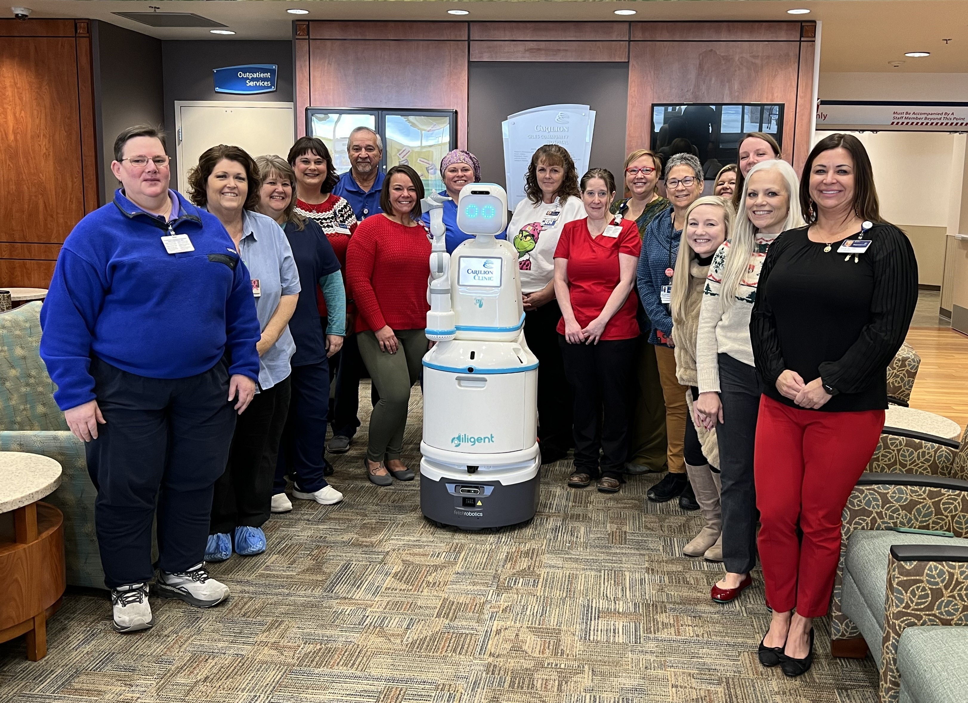 CGCH leaders meet one of the Moxi robots. 