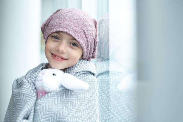 girl wrapped in a blanket holding stuffed bunny