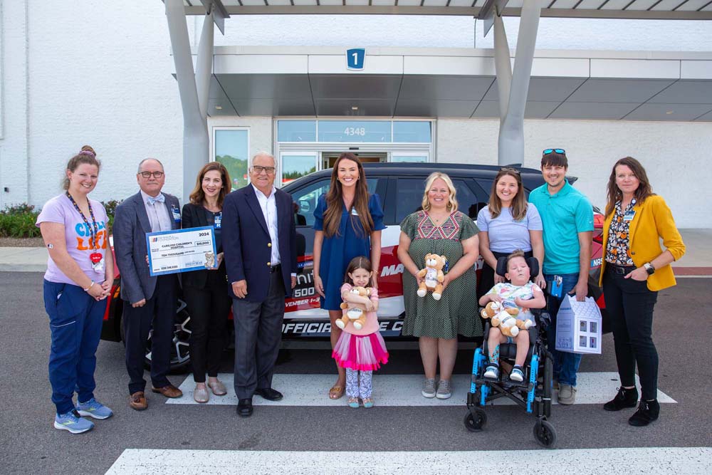 The NASCAR Foundation, Carilion Children's staff and patients pose for photo with the Martinsville Speedway pace car. 