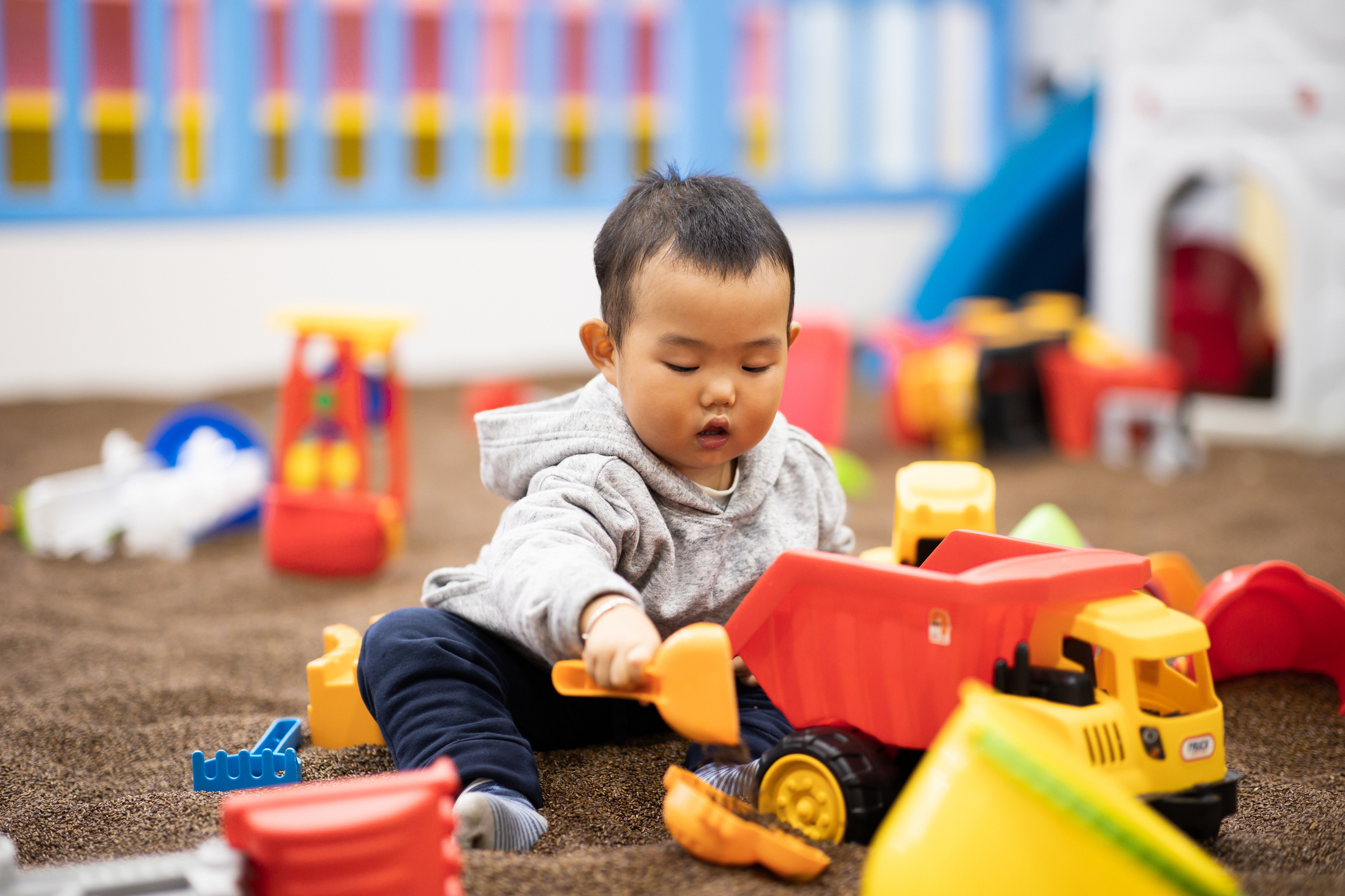 toddler playing with trucks