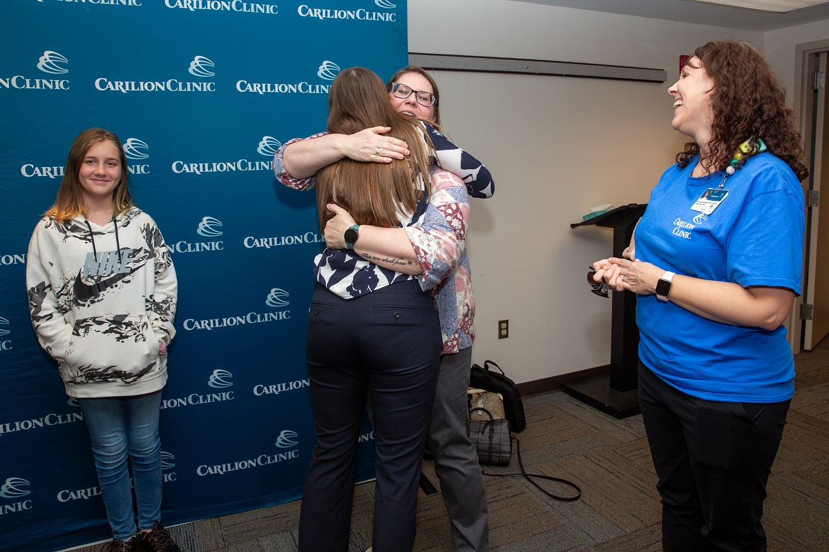 YES participant Laura Foretich hugging friends