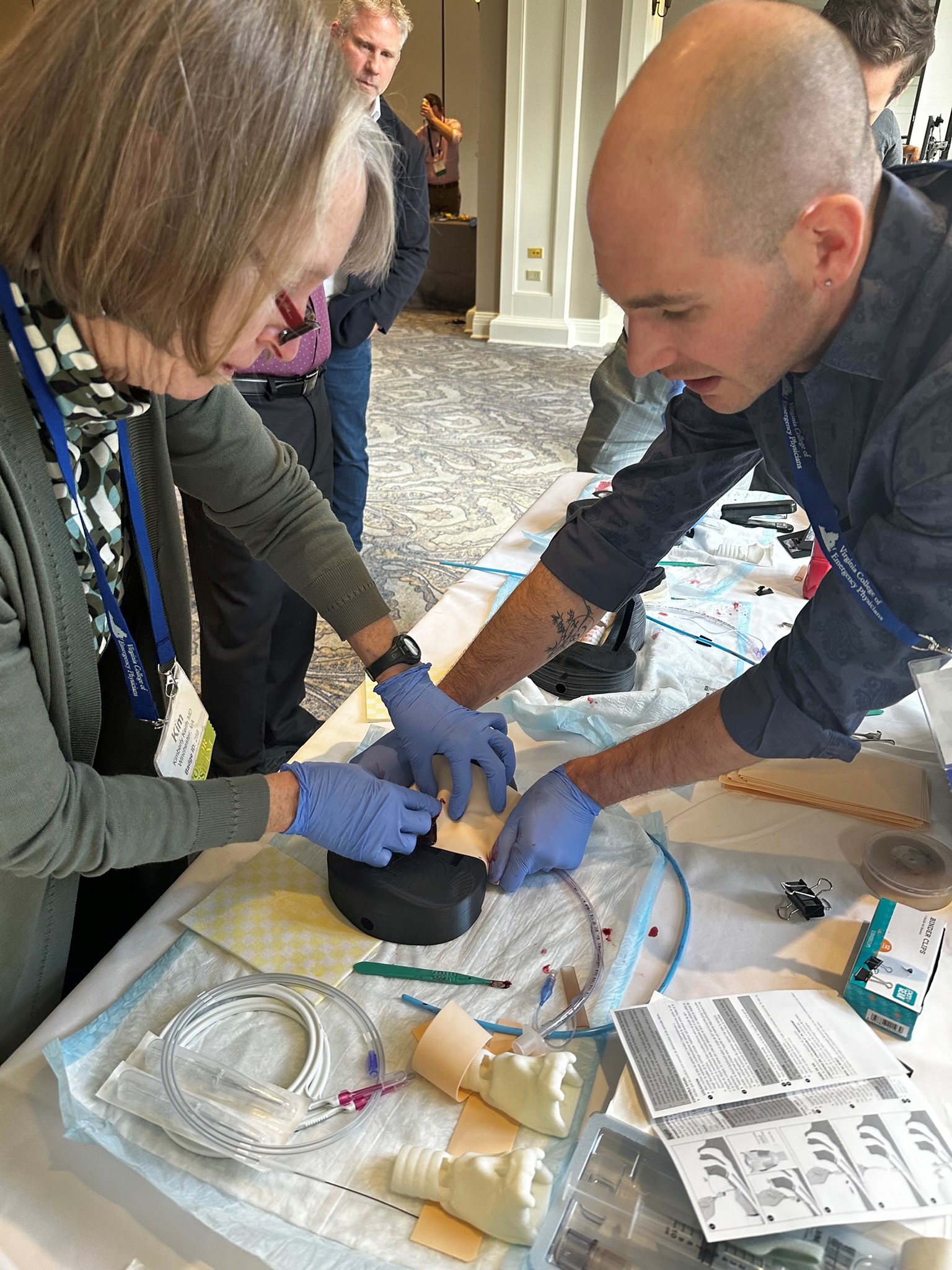 Emergency Medicine physicians train to perform cricothyrotomy.