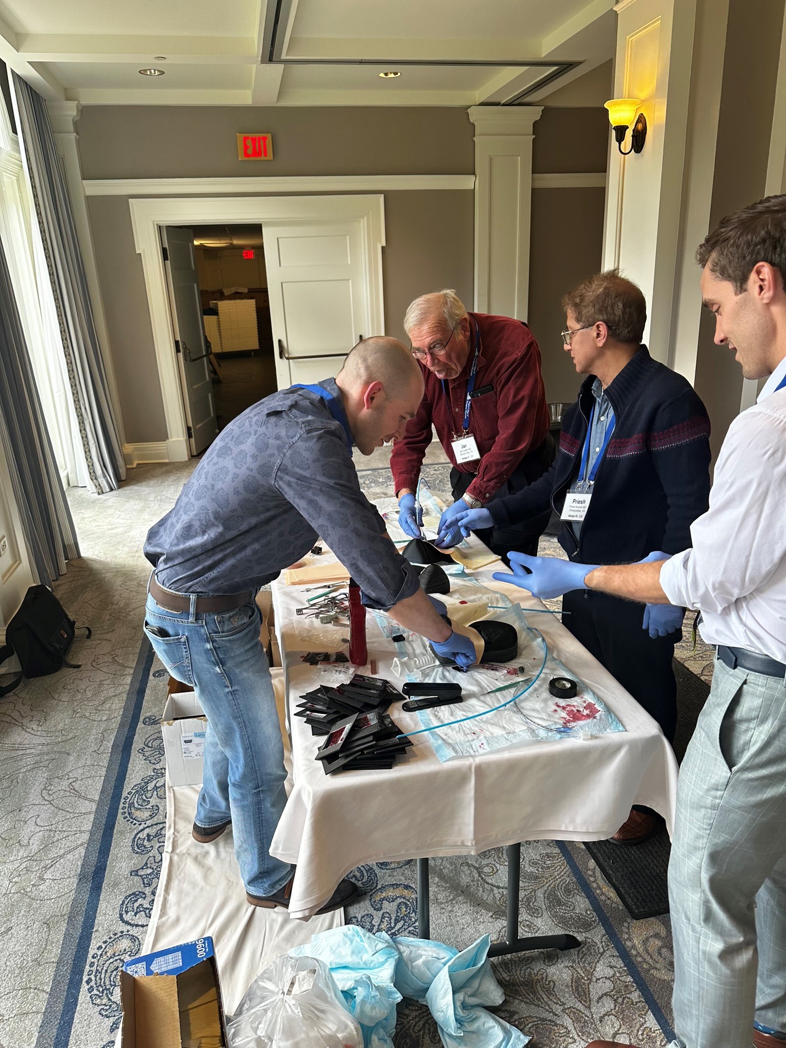Emergency Medicine physicians train to perform cricothyrotomy.
