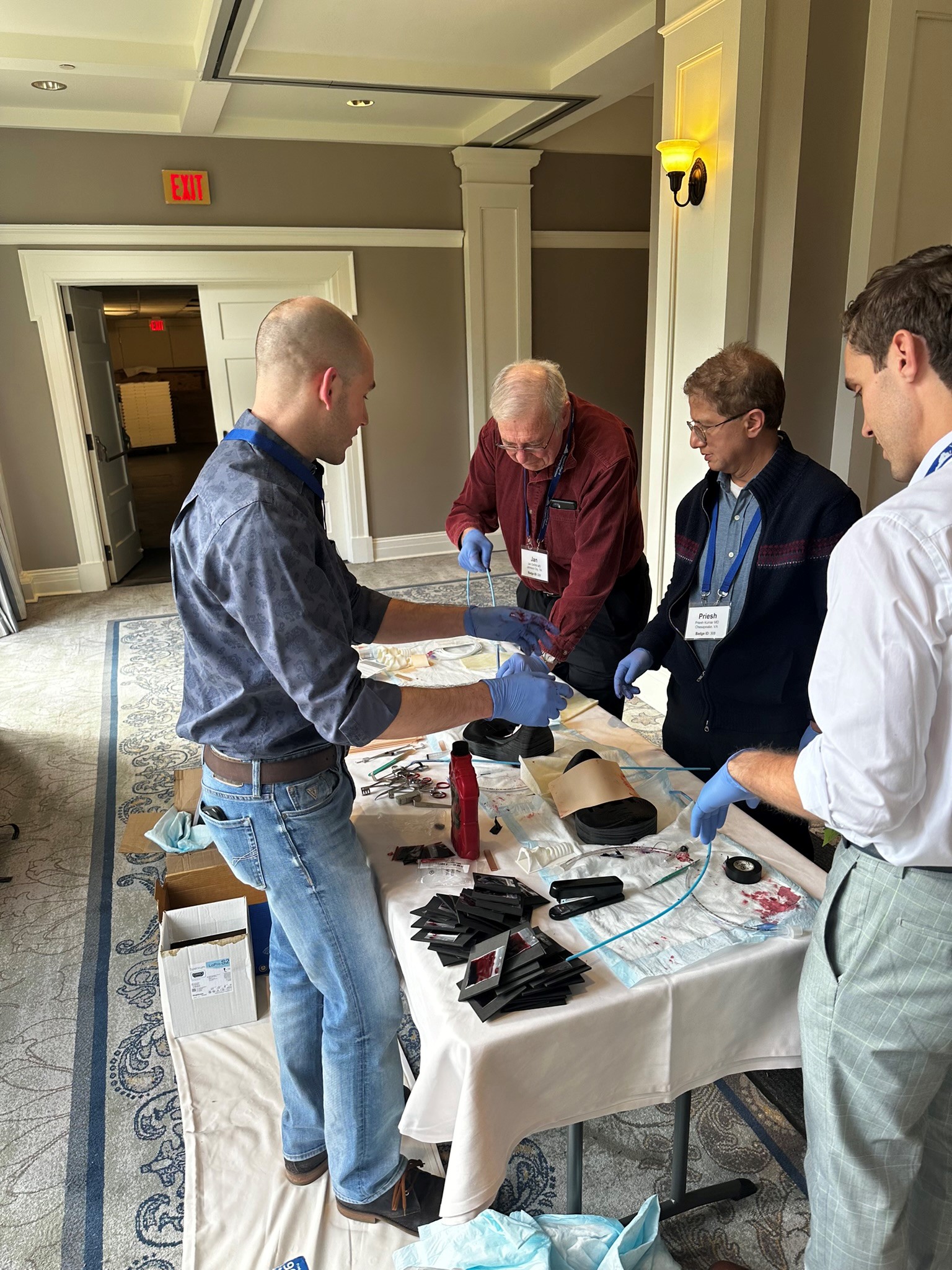 Emergency Medicine physicians train to perform cricothyrotomy.