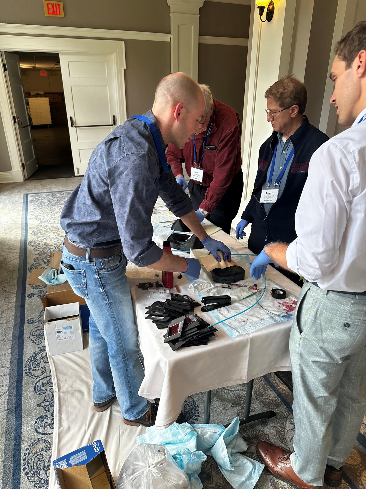 Emergency Medicine physicians train to perform cricothyrotomy.