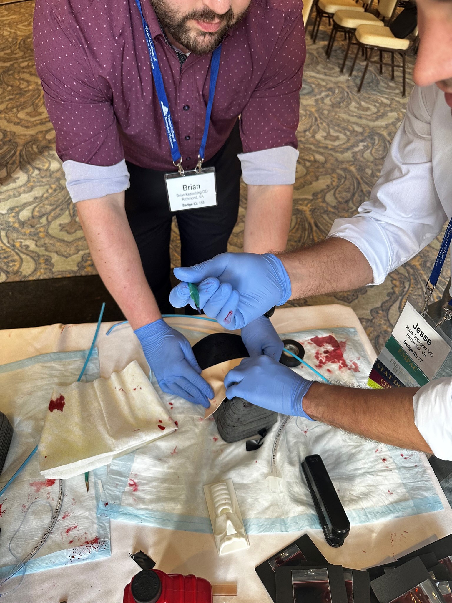 Emergency Medicine physicians train to perform cricothyrotomy.