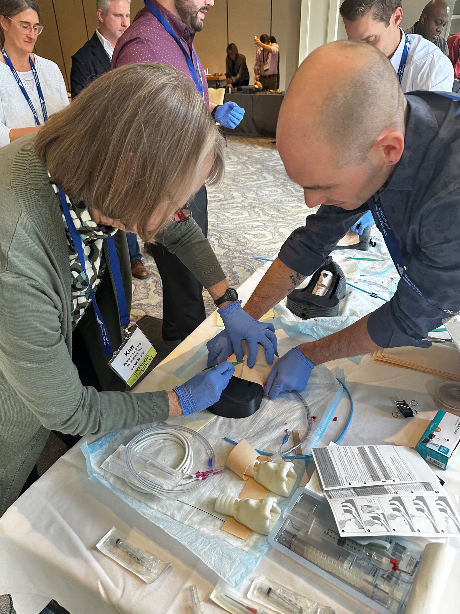 Emergency Medicine physicians train to perform cricothyrotomy.
