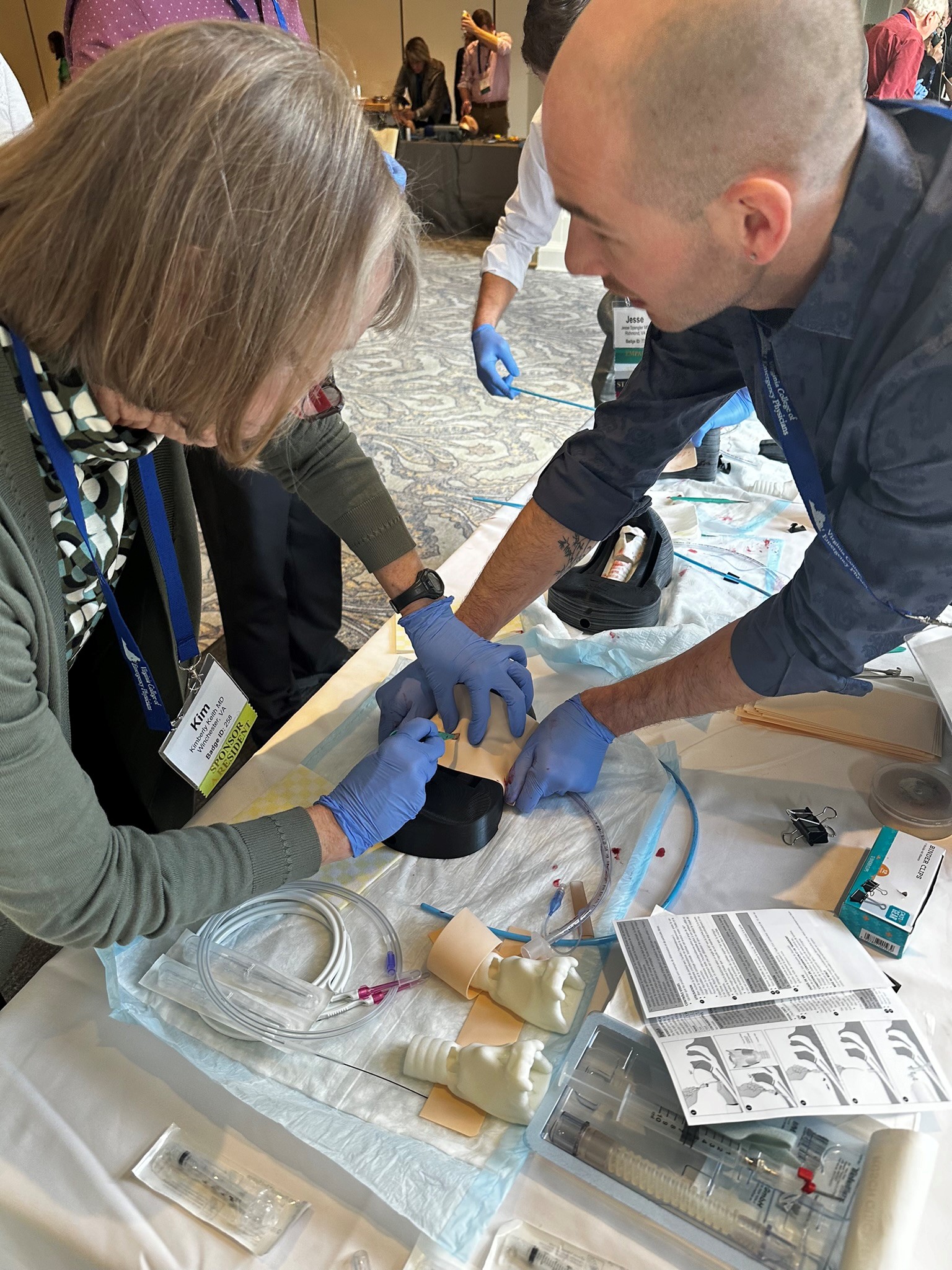 Emergency Medicine physicians train to perform cricothyrotomy.