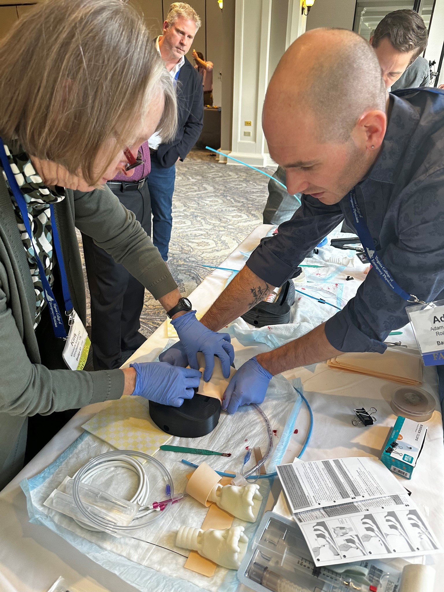 Emergency Medicine physicians train to perform cricothyrotomy.