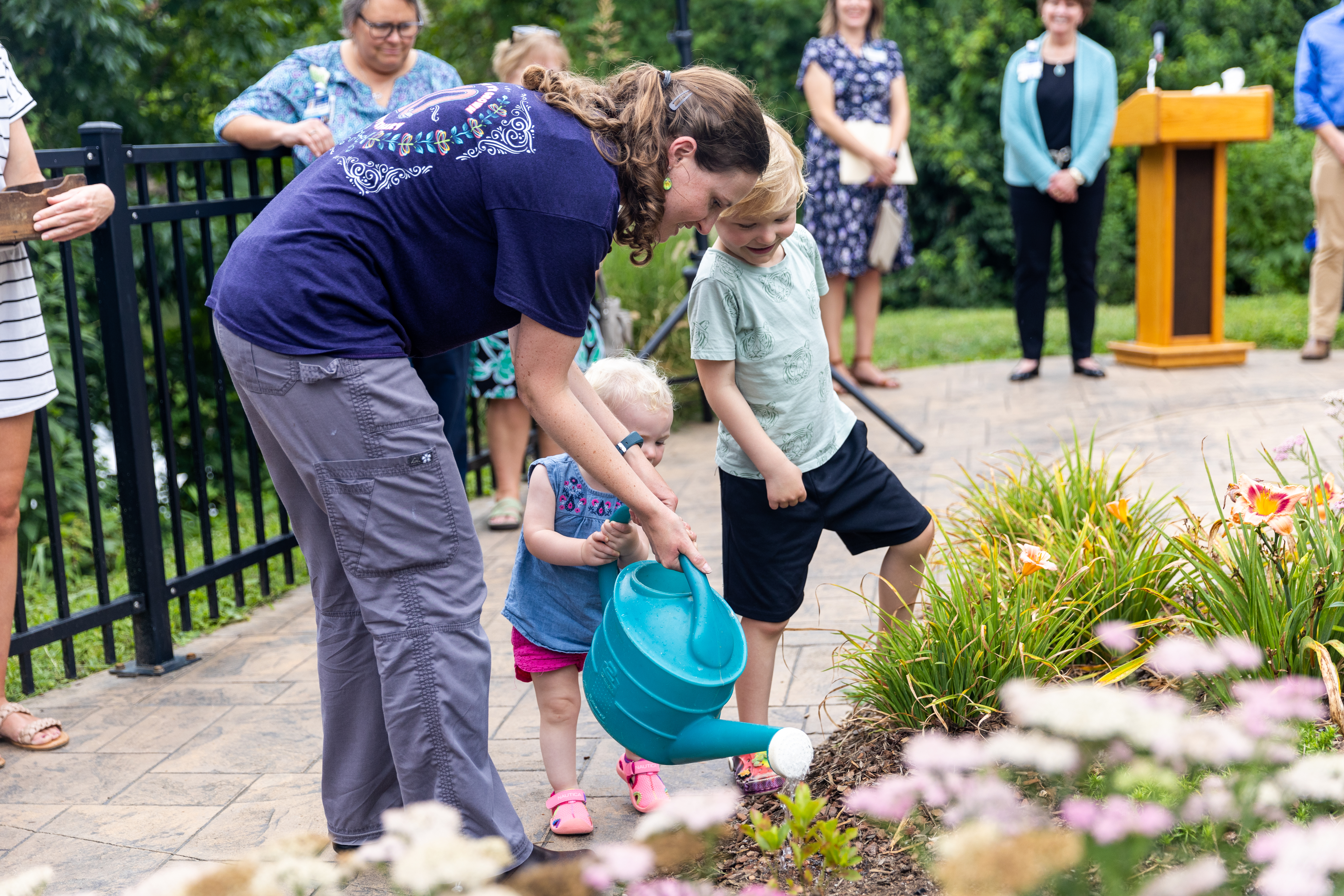 Community members tend to the Keeley Healing Garden at the Forget-Me-Not Seed Planting Ceremony