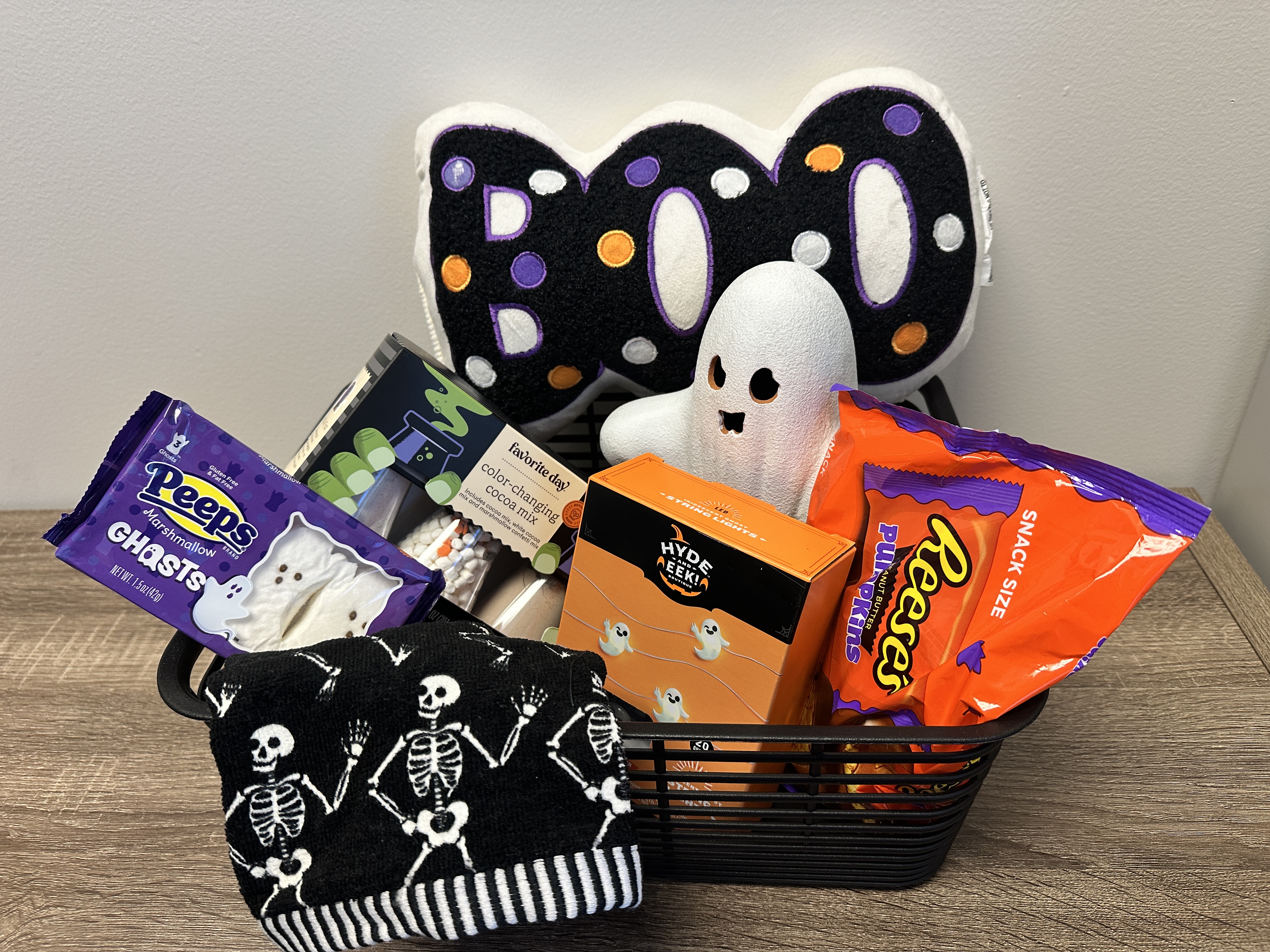 Boo Basket: accent pillow, hand towels, ghost string lights, hot cocoa kit, Peeps marshmallows, Reese's pumpkins