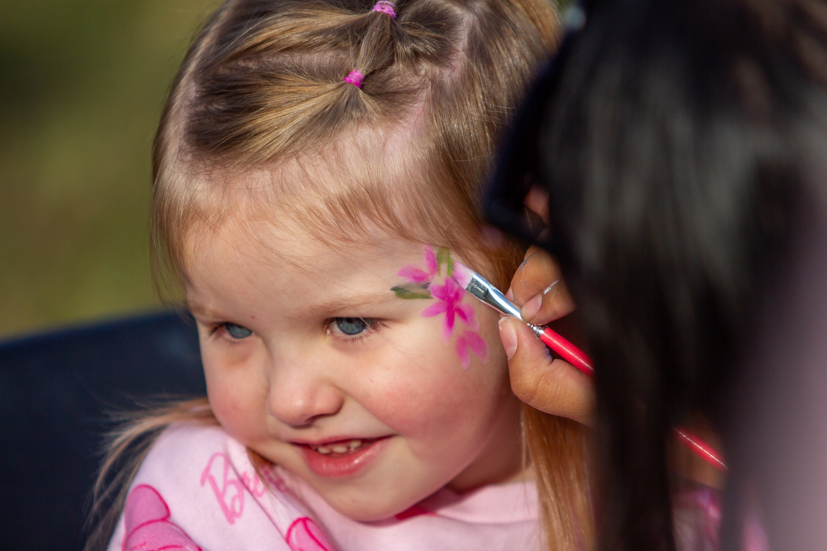 Girl enjoys the face painting station