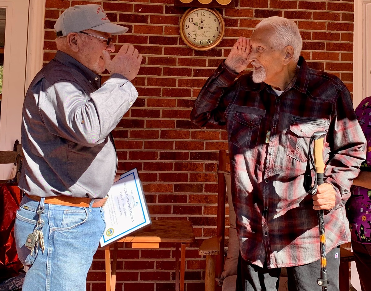 An Army Veteran is saluted in appreciation and gratitude for his service by a WHV Veteran volunteer.