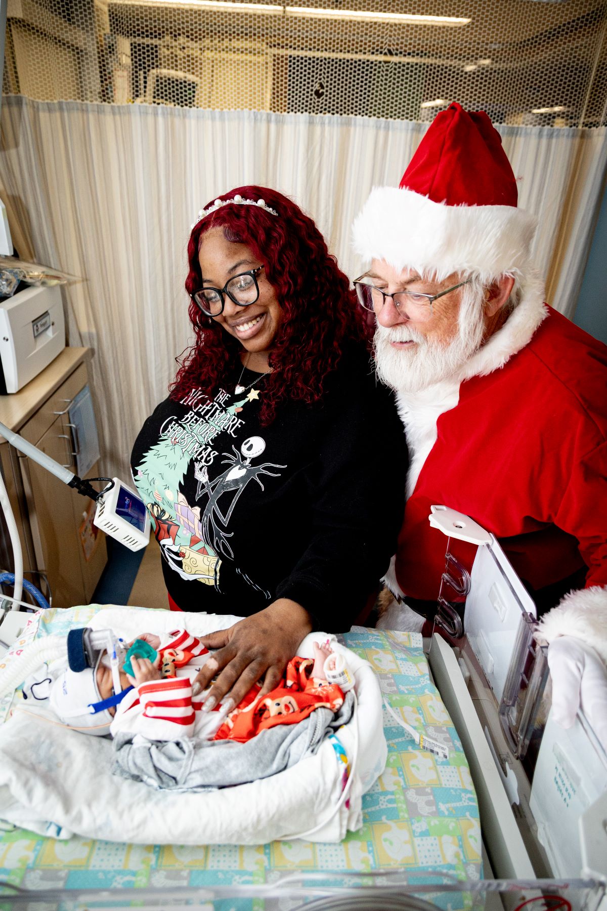 Santa visiting with patient and family member