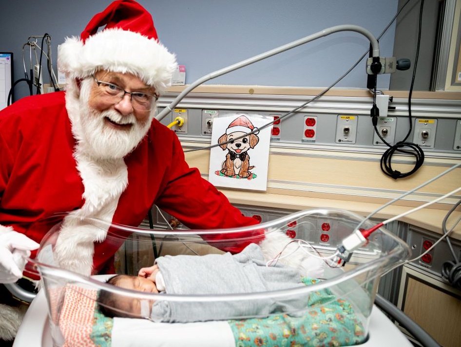 Santa visits a patient in the NICU