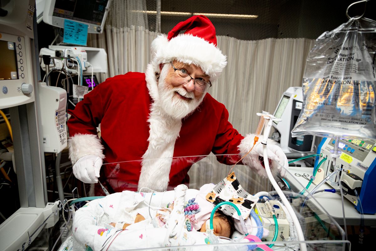 Santa with sleeping NICU patient