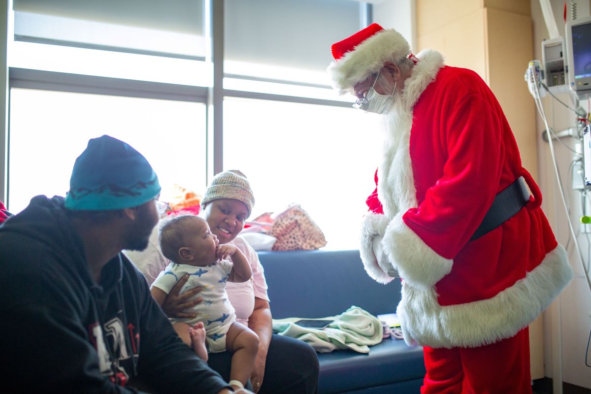 Santa greeting patient and family