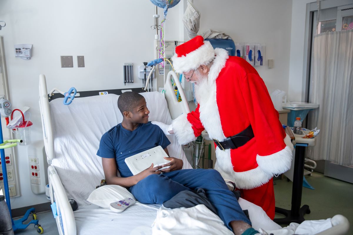 Santa visiting another patient at their bedside