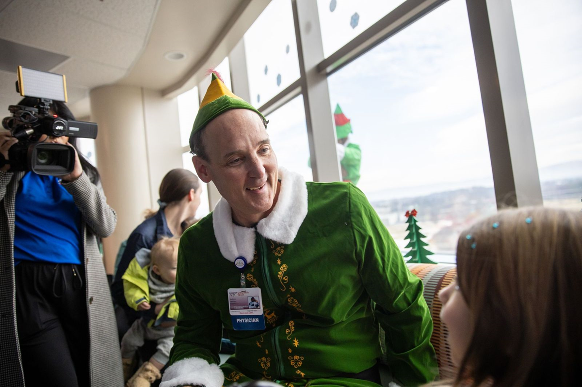 Physician elf visits with patient