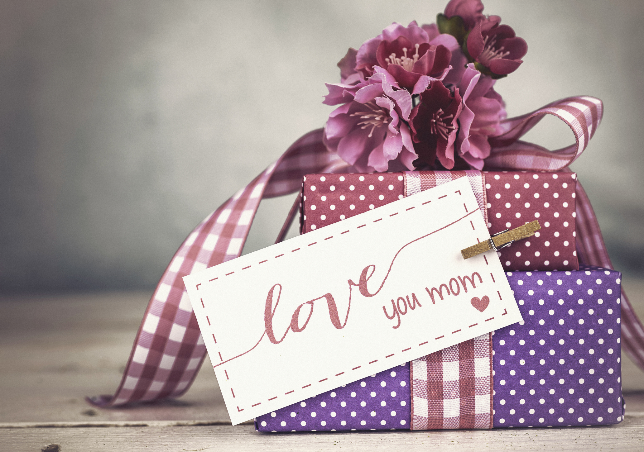 Wrapped gifts with tag reading "love you mom"