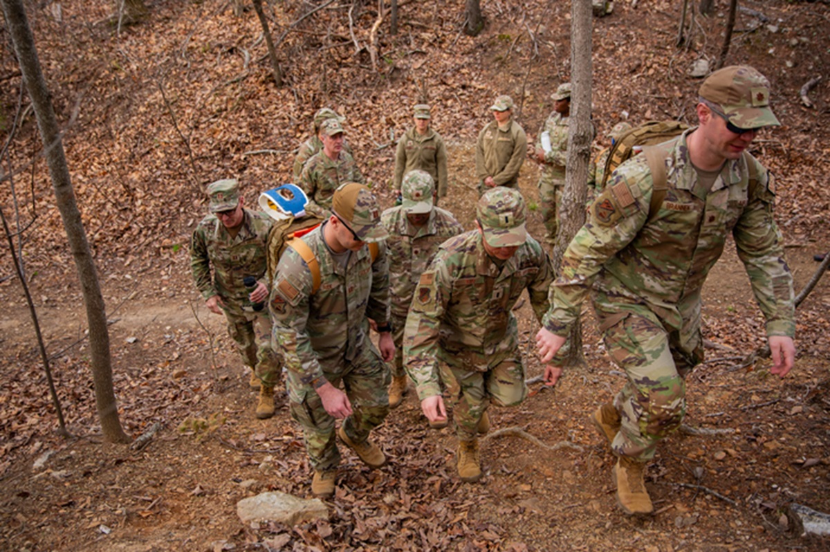 Guardsmen climb steep terrain as they approach the scenario set up by the Sim Center.