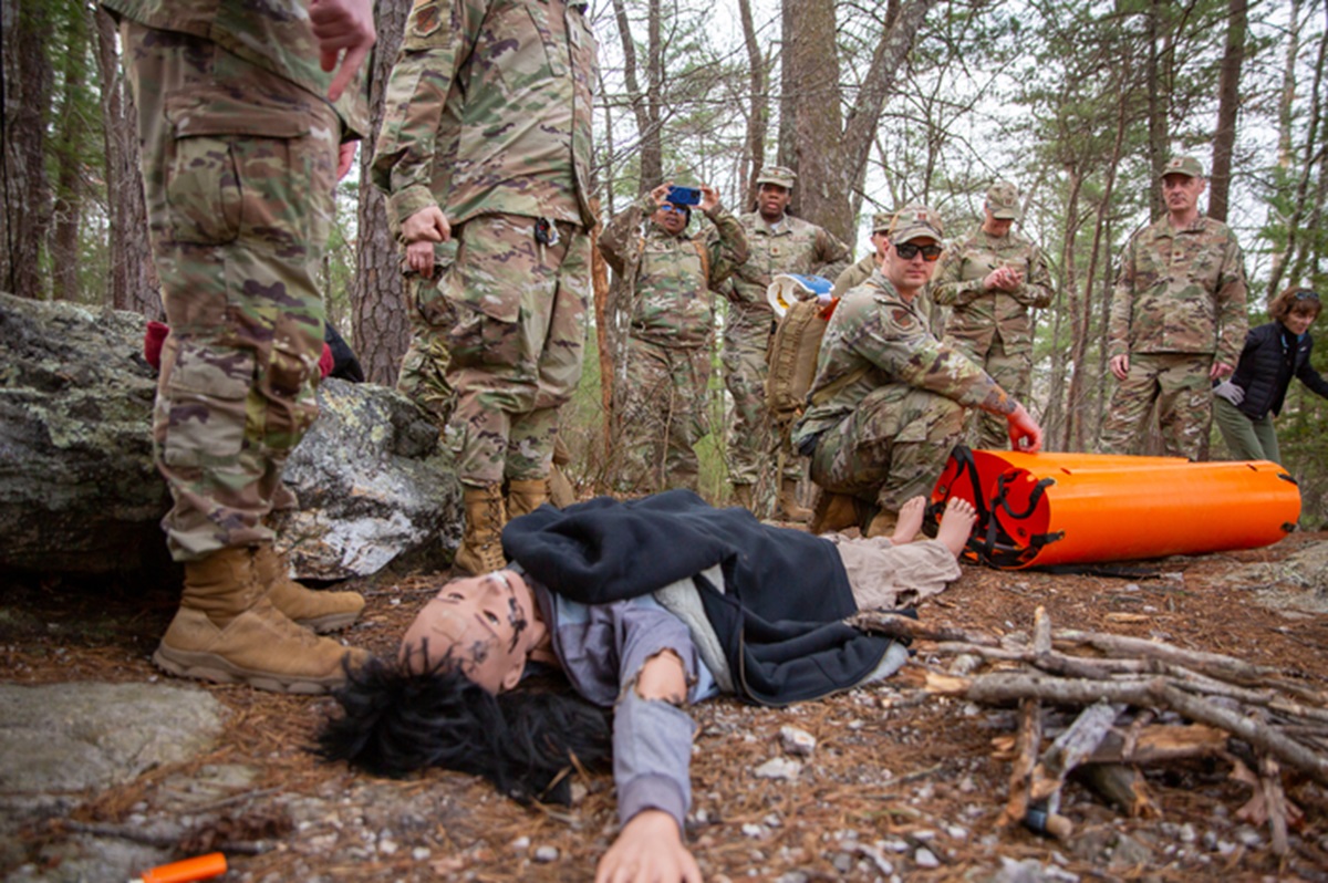 Guardsmen prepare to recover a second patient in the scenario. The patient is a manikin.