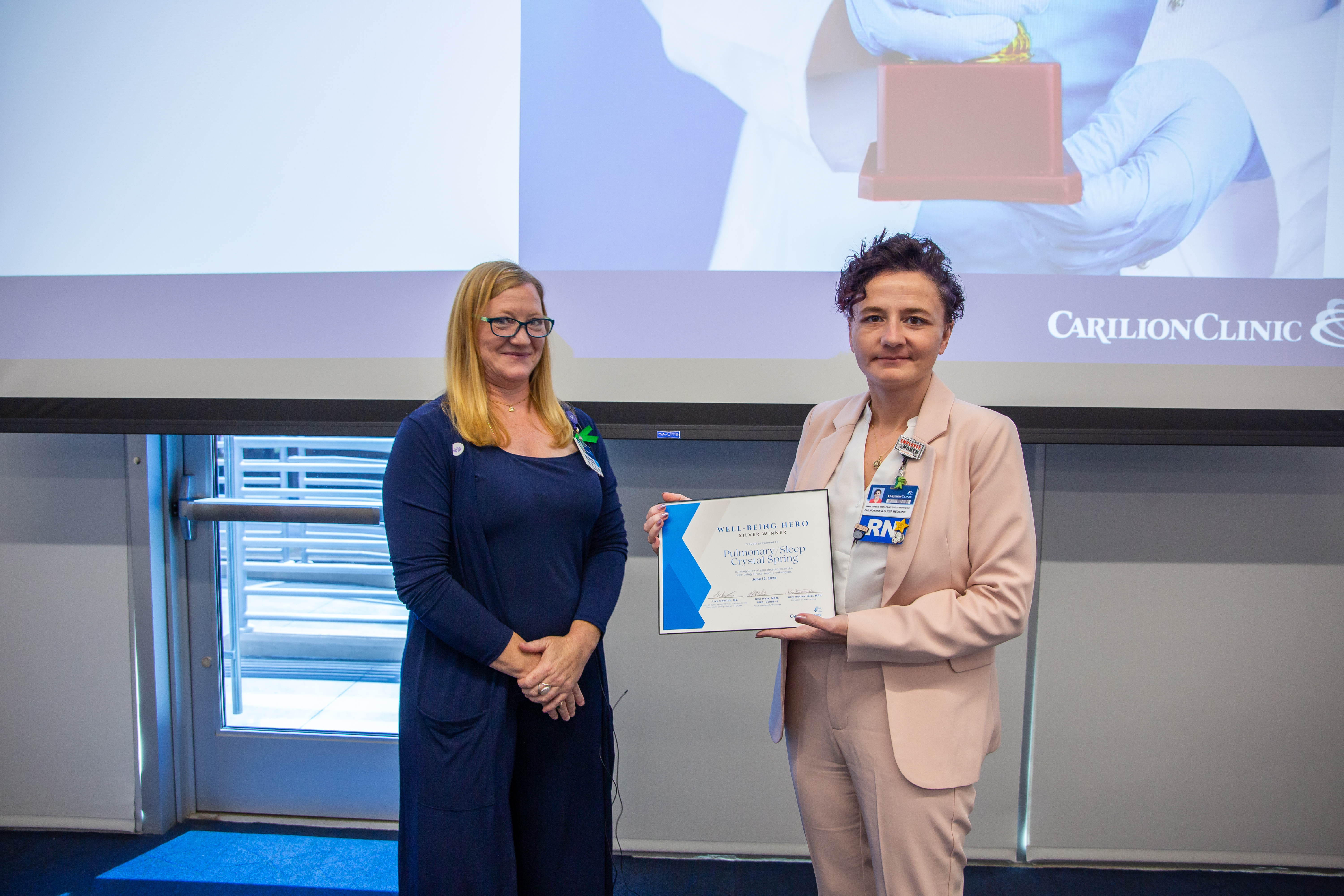 Jamie Gheen accepting the Well-Being Team Silver Award on behalf of Pulmonary & Sleep Medicine – Crystal Spring