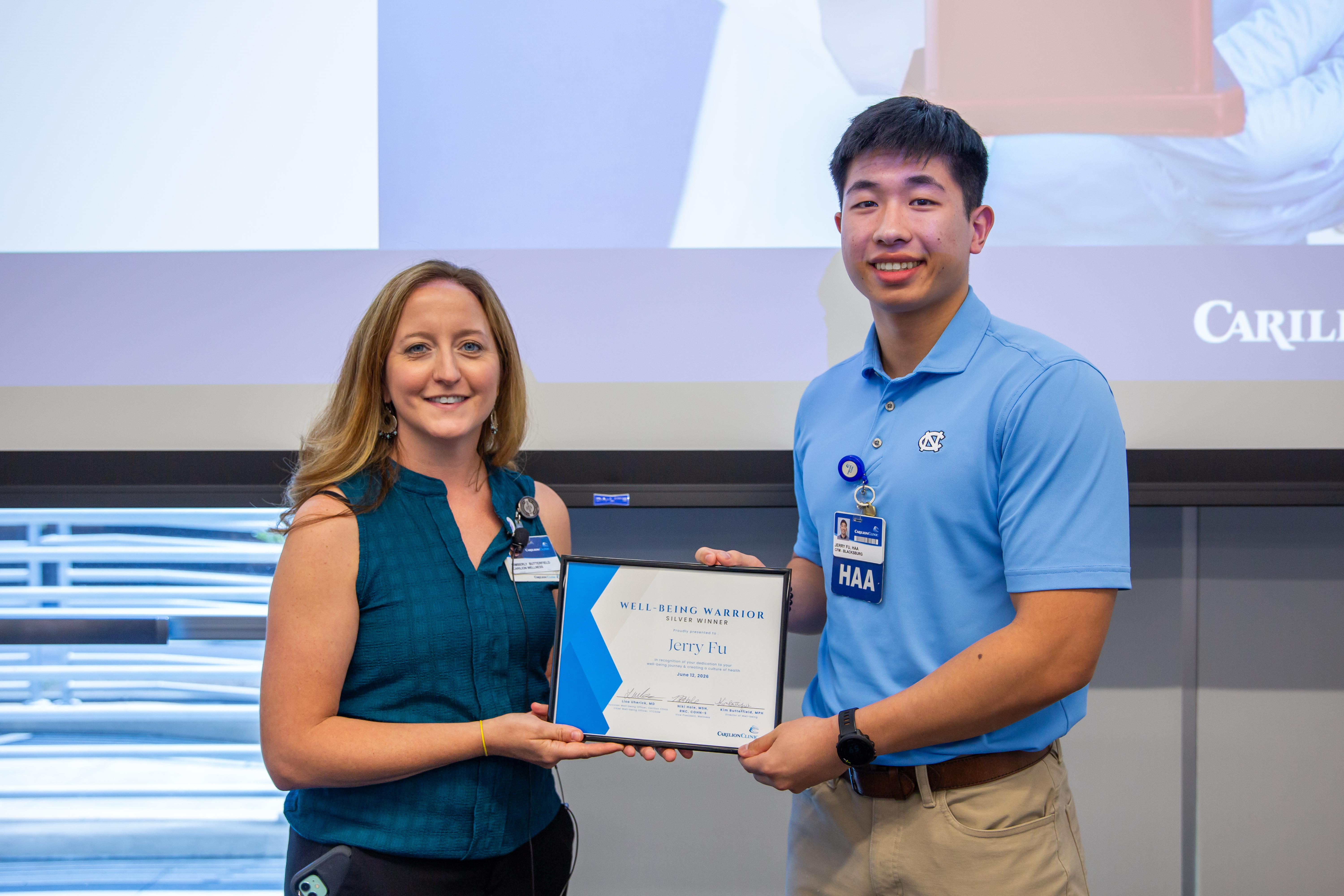 Jerry Fu receiving the Well-Being Warrior Silver Award