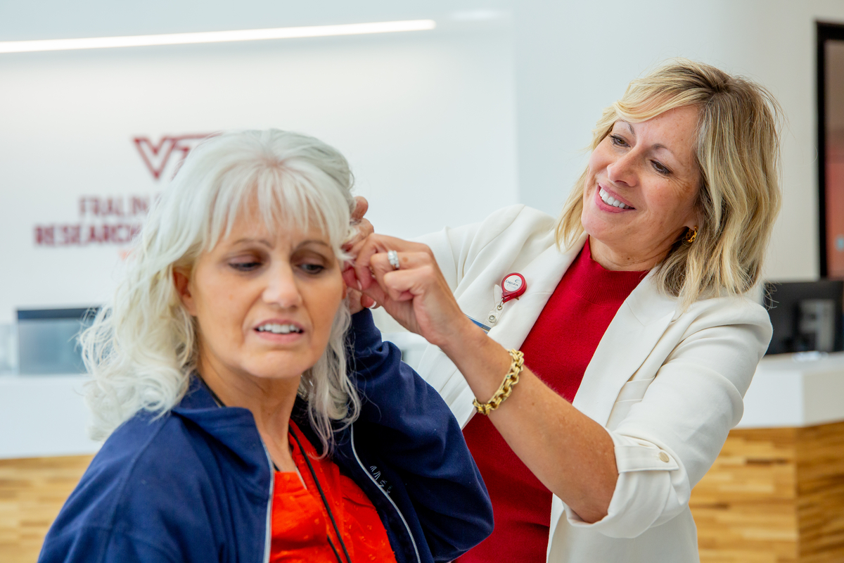 Wellness Manager Julie Blanchard applies AcuWellness treatment. 