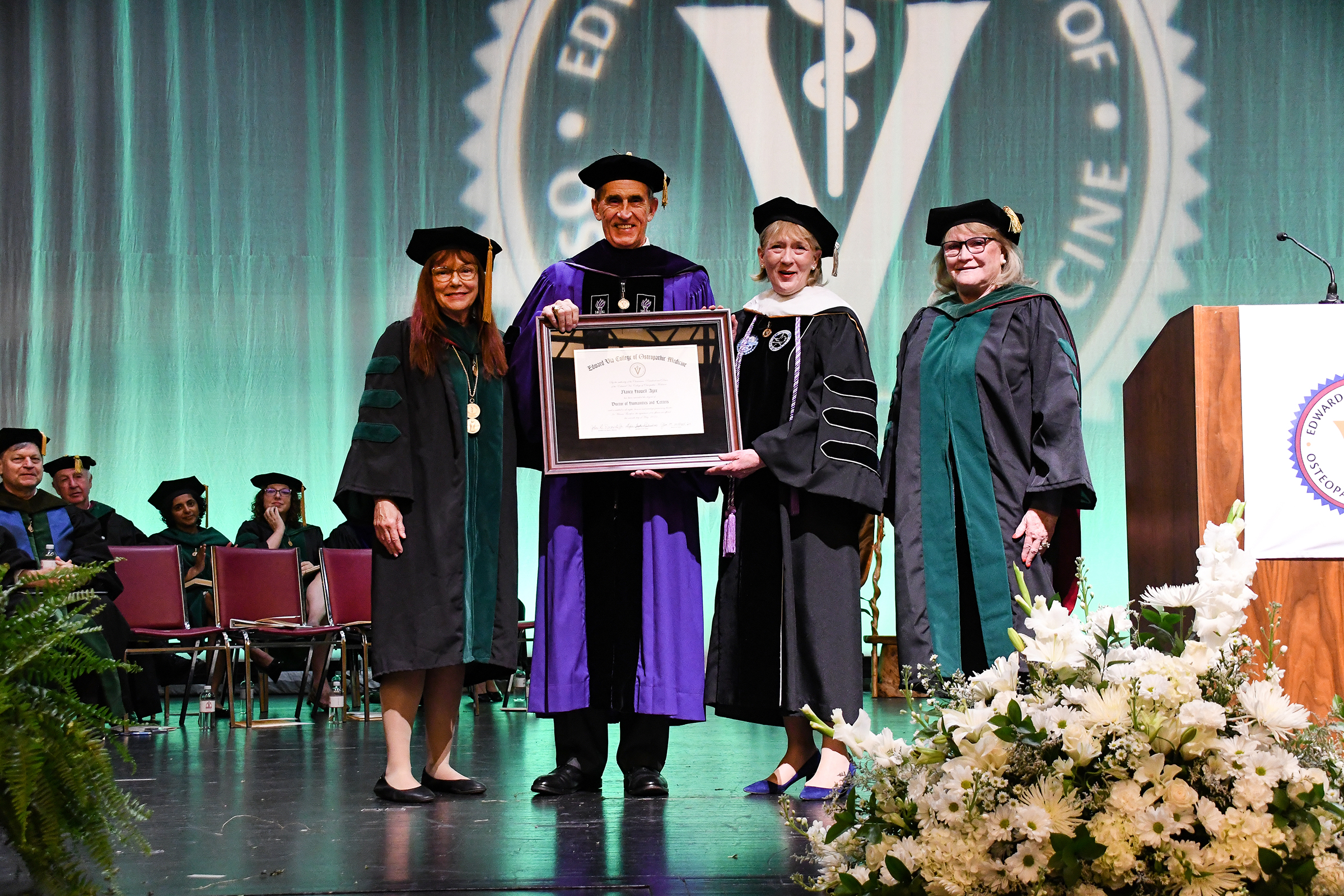 Nancy Howell Agee on-stage receiving her honorary degree from the Edward Via College of Osteopathic Medicine.